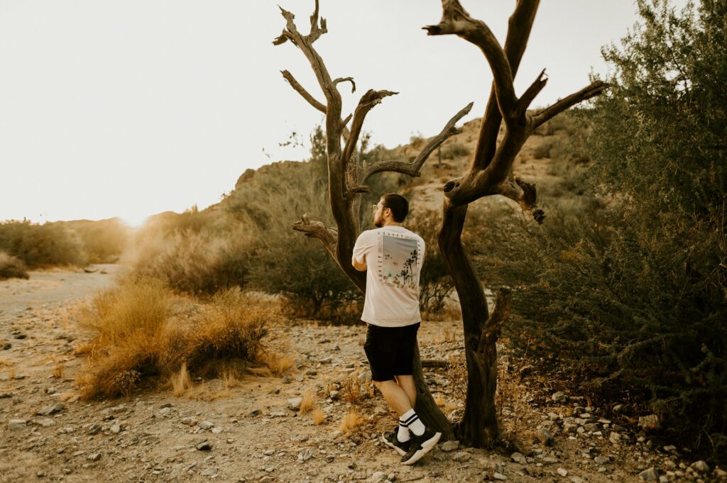 A person standing by a tree in Phoenix, AZ